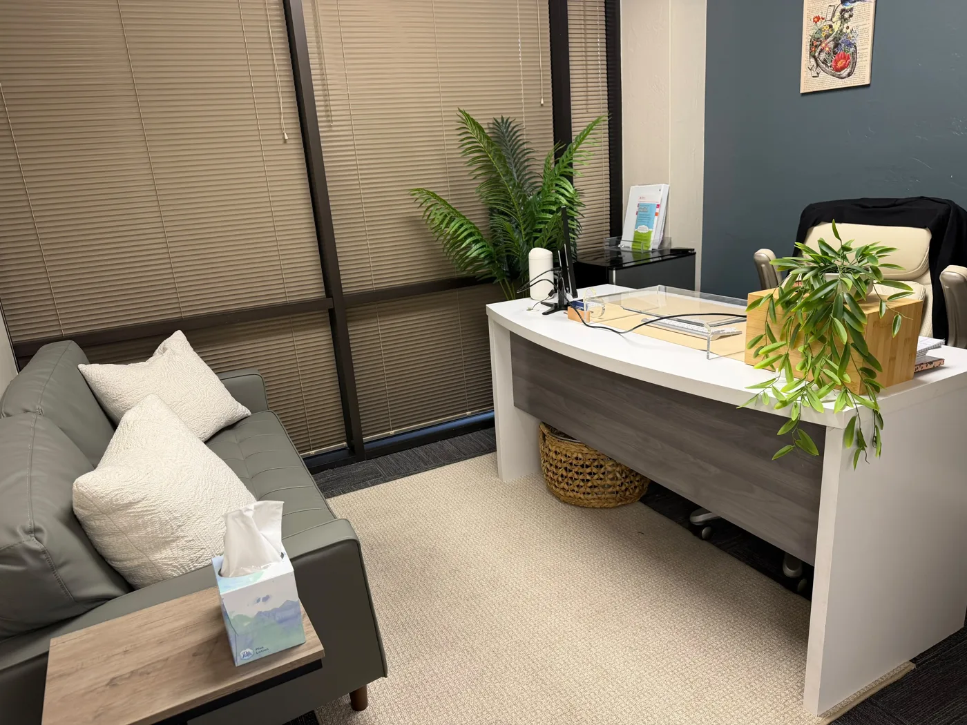 Consultation room with a desk and sofa at our Phoenix office