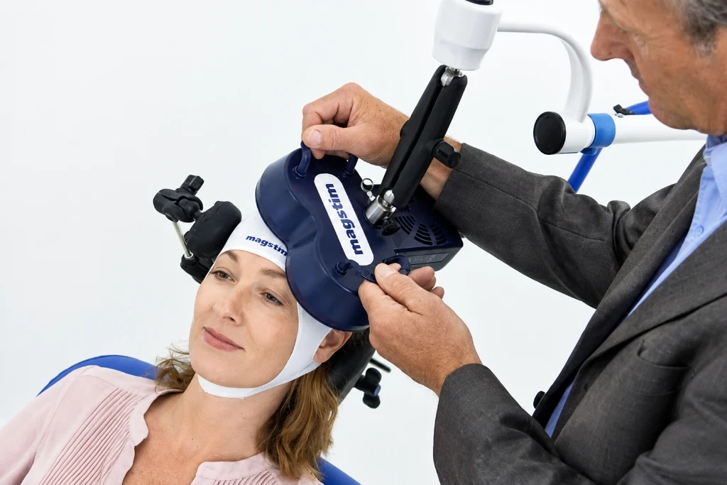 Psychiatric specialist positioning TMS therapy magnetic coil on patient for targeted anxiety and depression relief